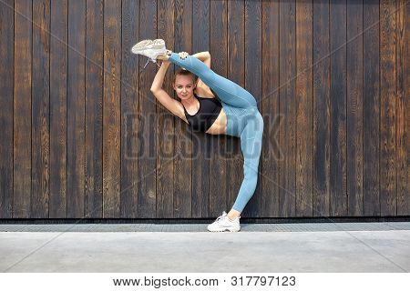 Beautiful Athletic Young Girl Gymnast In Sportswear, Working Out, Element Of Gymnastics, Doing The S