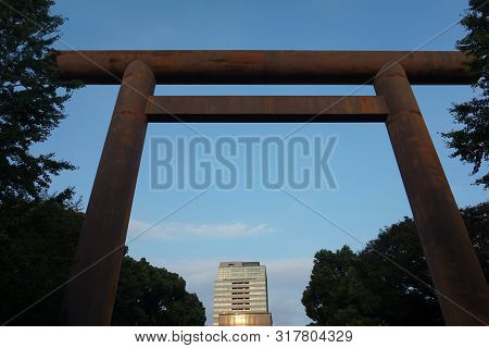 Tokyo / Japan - September, 16 2018: Torii Traditional Japanese Gate. Modern Buildings In The Backgro