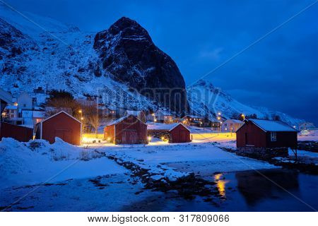 Ramberg village with red traditional rorbue houses in the night. Ramberg, Flakstad, Nordland, Norway