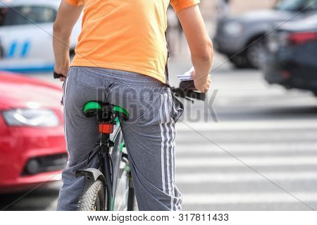 Saint Petersbourg, Russia - August, 14, 2019: Bicyclist waiting on a pedestrian crossroad in Saint Petersbourg