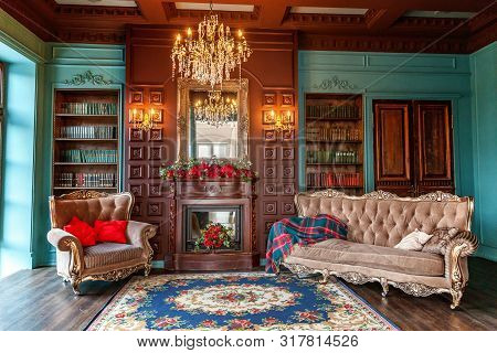 Luxury Classic Interior Of Home Library. Sitting Room With Bookshelf, Books, Arm Chair, Sofa And Fir