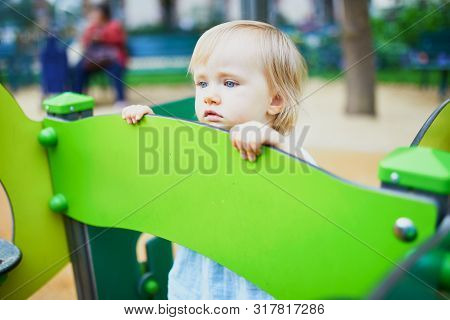 Adorable Toddler Feeling Sad On Playground. Outdoor Activities For Kids