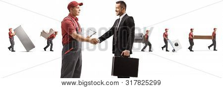 Full length profile shot of a worker and businessman shaking hands and movers carrying appliences and furniture isolated on white background