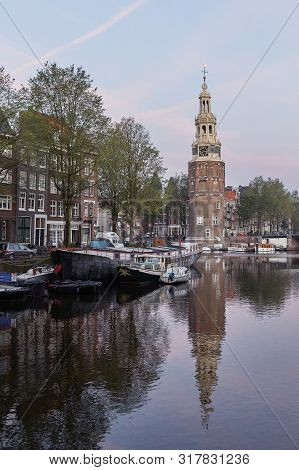 One Of The Churches Of Amsterdam In Netherlands, Unique With City Scene Along Canal In Morning Natur