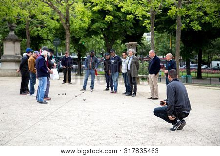 Paris, France - May 11, 2017: Group Of Men Playing Petanque In A Public Park.