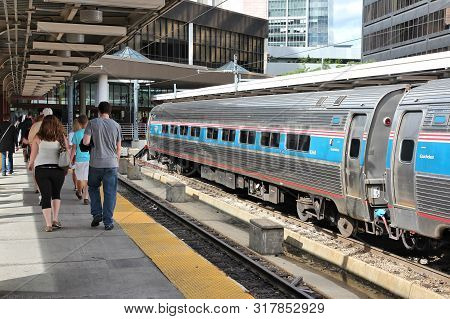 Boston, Usa - June 8, 2013: Passengers Visit South Station Train Terminal In Boston. The Railway Sta