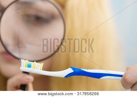 Beautiful Perfectionist Young Woman Checking Her Tooth Brush Through Manifying Loupe Glass. Hygiene,