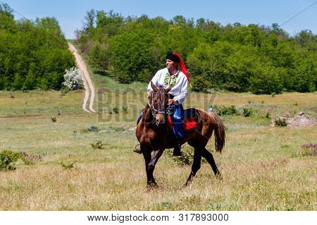 Dnipropetrovsk Region, Ukraine - June 2, 2018: Ukrainian Cossack Riding A Horse During Ethno-rock Fe