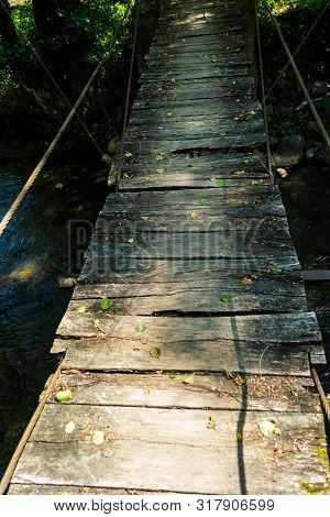 Old Wooden Bridge Over The Iza River, Maramures, Romania.