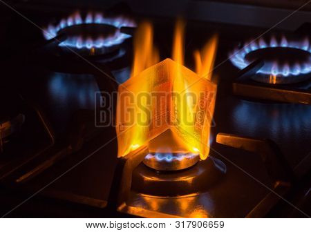 Burning Bill Of Hundred Ukraine Hrivnas On A Gas Burner Flame, Expensive Natural Gas Concept