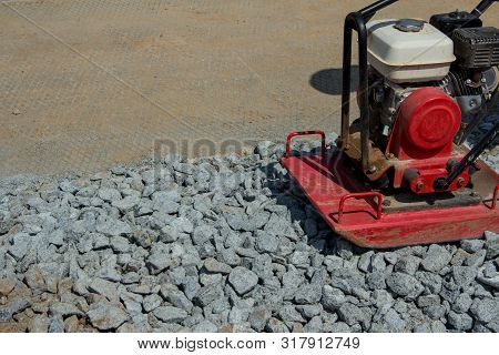 Rammer At Work. Rammer Rubble On The Edge Of The Road. Construction Work On The Road