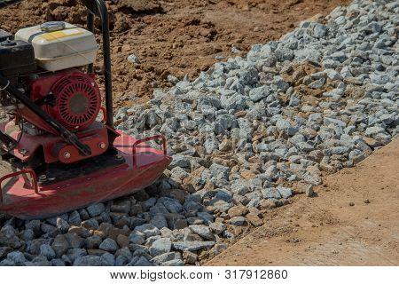 Rammer At Work. Rammer Rubble On The Edge Of The Road. Construction Work On The Road