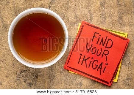find your ikigai handwriting, reminder note with a cup of tea - Japanese concept  of a reason for being of life purpose
