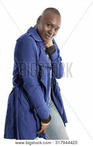 Black African American Fashion Model With Bald Hairstyle Confidently Posing With A Vibrant Blue Colo