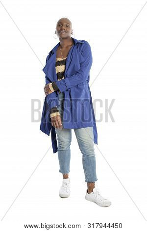 Black African American Fashion Model With Bald Hairstyle Confidently Posing With A Vibrant Blue Colo