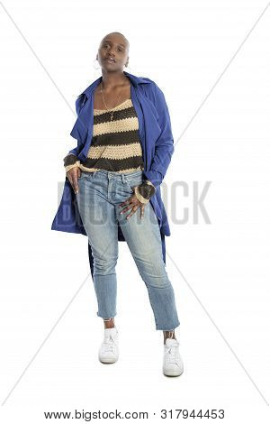 Black African American Fashion Model With Bald Hairstyle Confidently Posing With A Vibrant Blue Colo