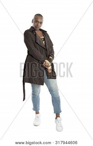Black African American Fashion Model With Bald Hairstyle Confidently Posing With A Vibrant Blue Colo