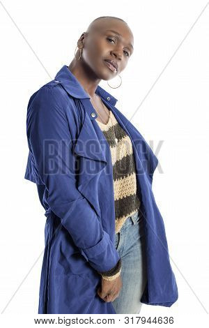 Black African American Fashion Model With Bald Hairstyle Confidently Posing With A Vibrant Blue Colo