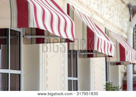 Tents And Windows Of A City Cafe. Red And White Stripes