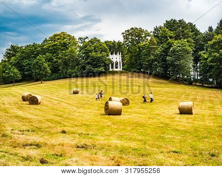 Painshill Park, Cobham Surrey, England. 4 August 2019. Painshill Park Surrey A Family Running Across