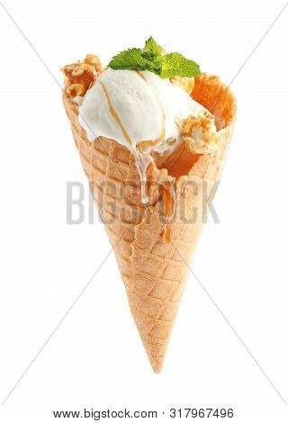 Delicious Ice Cream With Caramel Sauce, Mint And Popcorn In Waffle Cone On White Background