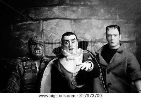 AUG 18 2019: Halloween concept of Frankenstein, Count Dracula and Werewolf - vintage retro movie poster look - Mego Corporation action figures