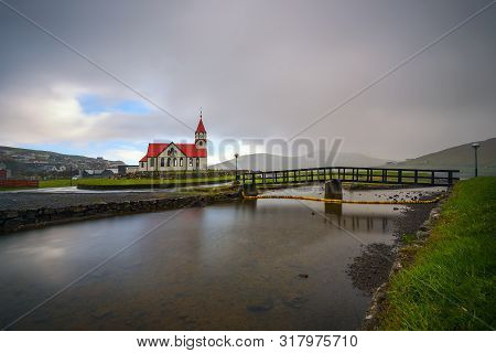 Sandavagur Church With Red Roof Also Called Sandavags Kirkja And The River Stora Located In The Pict