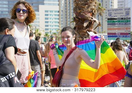 Lesbians Walking In The Gay Pride Parade. Parade Of Tolerance. The Annual Parade Lgbt. Rainbow Flags