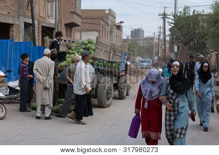 Kashgar, Xinjiang, China - August 14, 2012: People Buying Watermelons In A Street Market In The City
