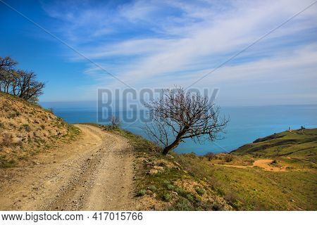 Dirt Winding Road To The Lighthouse On The Beach