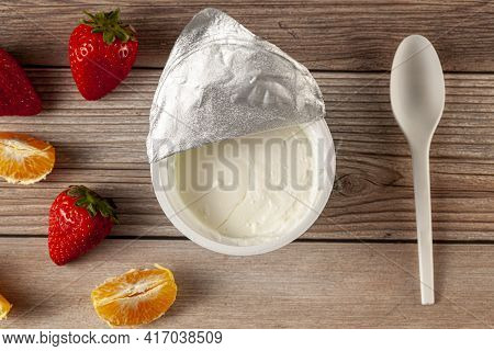 Flat Lay Image Of A Store Bought Plastic Cup Of Plain Low Fat Greek Yogurt With The Aluminum Foil Se