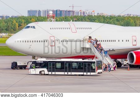 Leaving Passengers From The Large Airliner By Stairs And Boarding Buses. Russia, Moscow Sheremetyevo