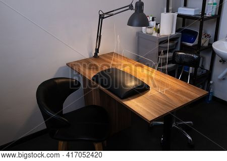 Manicurist Workplace With Plexiglass Sneeze Guard For Social Distancing During Coronavirus Pandemic 