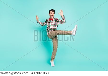 Photo Of Man Dance Raise Hands Open Mouth Look Empty Space Wear Plaid Shirt Bow Pants Isolated Blue 