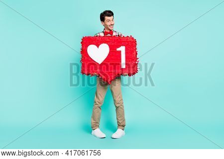 Photo Of Cheerful Guy Hold Big Like Pinata Look Camera Wear Plaid Shirt Bowtie Isolated Blue Color B
