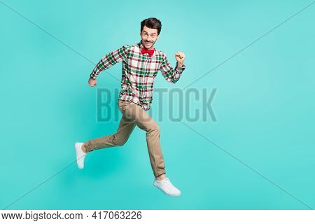Photo Of Guy Jump Hurry Run Wear Checkered Shirt Bow Tie Trousers Footwear Isolated Blue Color Backg