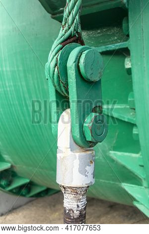 Close Up View Of Of An Old Green Steel Shackle With A Large Nut And Rusty Steel Cable