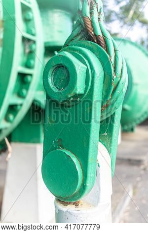 Close Up View Of Of An Old Green Steel Shackle With A Large Nut And Rusty Steel Cable