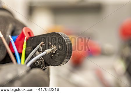 Wire Crimping Tool. Close-up Crimper. A Man Holds A Wire Crimper. Equipment For The Electrician. Cop