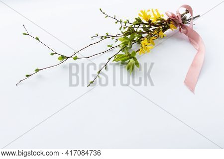 Spring Bouquet Of Twigs With First Leaves And Flowers.