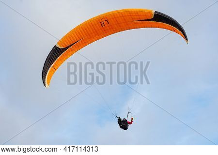 Man Doing Sport, Para-glider In The Clouded Sky. Paragliding Is An Extreme Sport And Recreation. Tor
