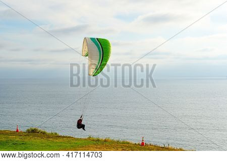 Man Doing Sport, Para-glider In The Clouded Sky. Paragliding Is An Extreme Sport And Recreation. Tor