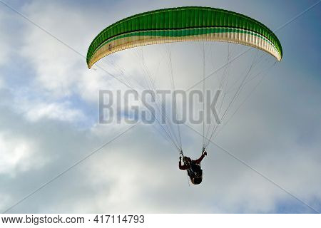 Man Doing Sport, Para-glider In The Clouded Sky. Paragliding Is An Extreme Sport And Recreation. Tor