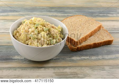Albacore Tuna Salad With Chopped Apple And Avocado In White Bowl Next To Two Whole Wheat Bead Slices