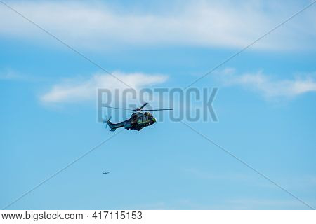 Sheriff Helicopter Hovering On A Beautiful Sky Background. Sheriff Department Helicopter On A Routin
