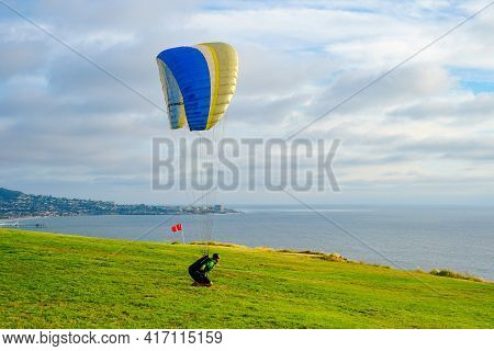 Man Doing Sport, Para-glider In The Clouded Sky. Paragliding Is An Extreme Sport And Recreation. Tor