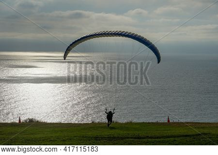 Man Doing Sport, Para-glider In The Clouded Sky. Paragliding Is An Extreme Sport And Recreation. Tor