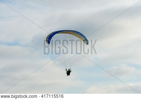 Man Doing Sport, Para-glider In The Clouded Sky. Paragliding Is An Extreme Sport And Recreation. Tor