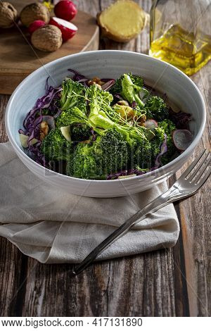 Plate With A Healthy Vegetarian Salad Of Steamed Broccoli, Fresh Radishes, Walnuts, Red Cabbage, Gin