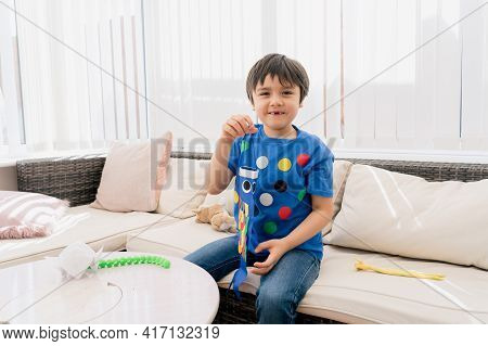 High Key Happy Kid Stay At Home Lying On Sofa Playing Koinobori (carp Streamers),child Boy Doing Jap